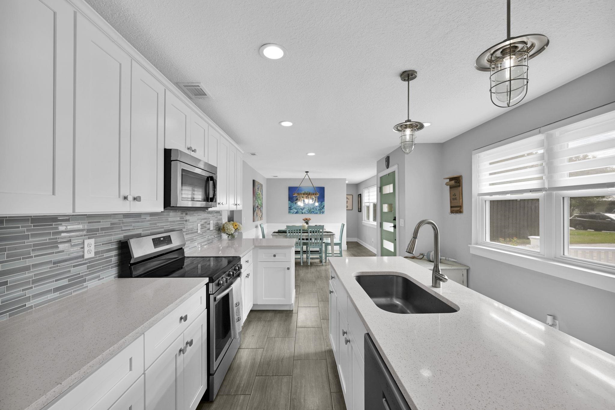 314 Arpieka Avenue St. Augustine, FL 32080 - Photo 10 of 28 a kitchen with stainless steel appliances a sink a stove top oven a counter space and cabinets