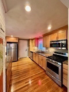 27 Sunset Drive Randolph, MA 02368 - Photo 6 of 37 a kitchen with stainless steel appliances a stove a sink and a refrigerator