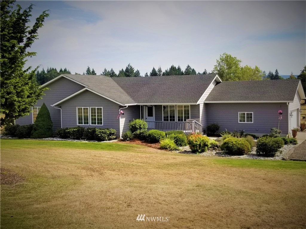 314 Spencer Road Toledo, WA 98591 - Photo 1 of 26 a front view of a house with a yard and garage