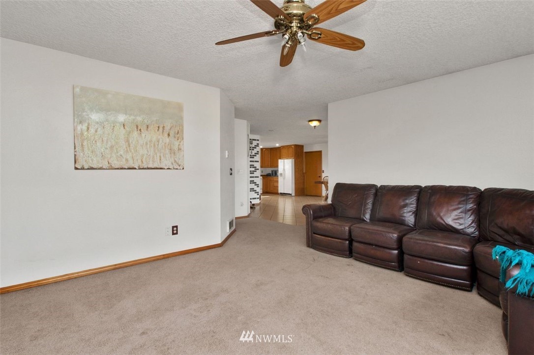 314 Spencer Road Toledo, WA 98591 - Photo 9 of 26 a living room with furniture and a chandelier