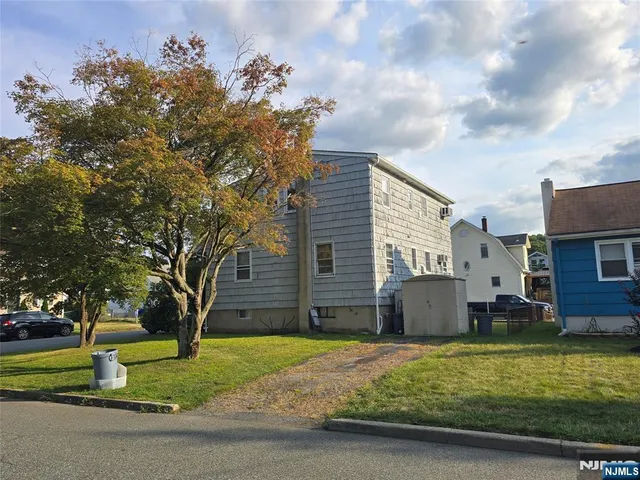 a backyard of a house with a garden and barbeque oven