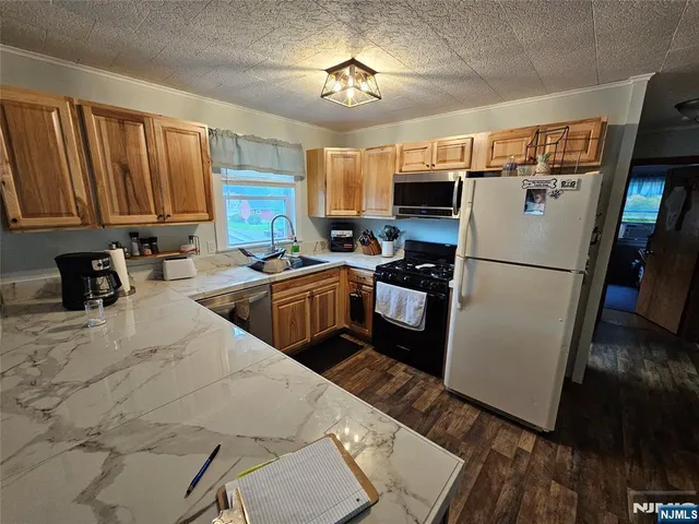 a kitchen with stainless steel appliances a refrigerator sink and cabinets