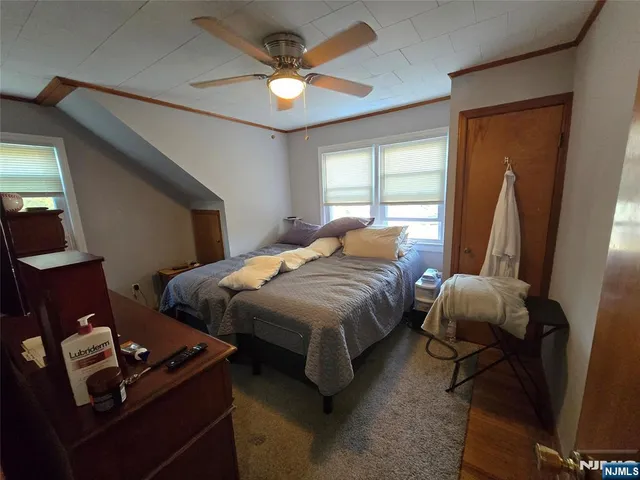 a bedroom with bed and a window