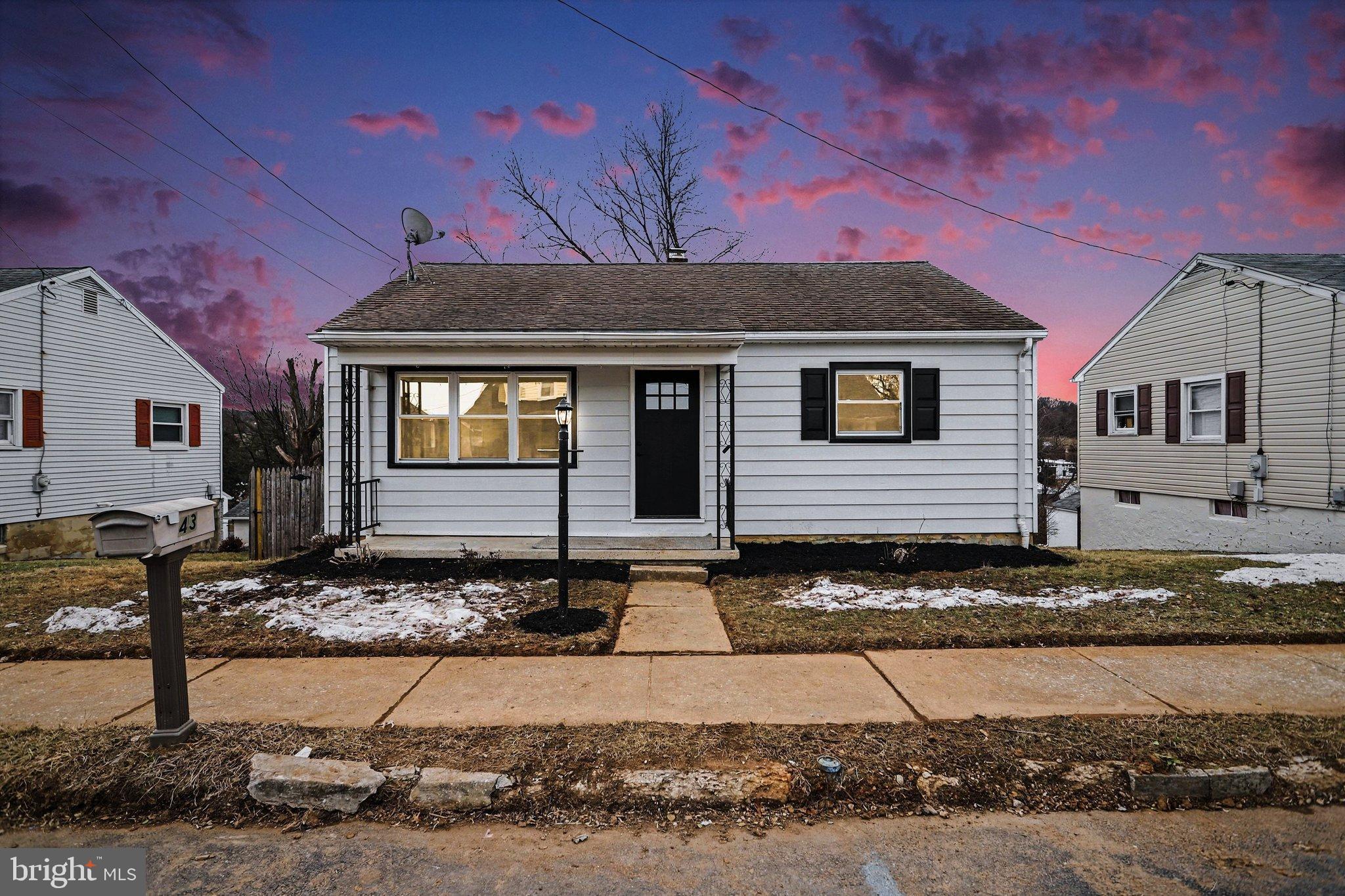 Charming home under a vibrant sunset sky.