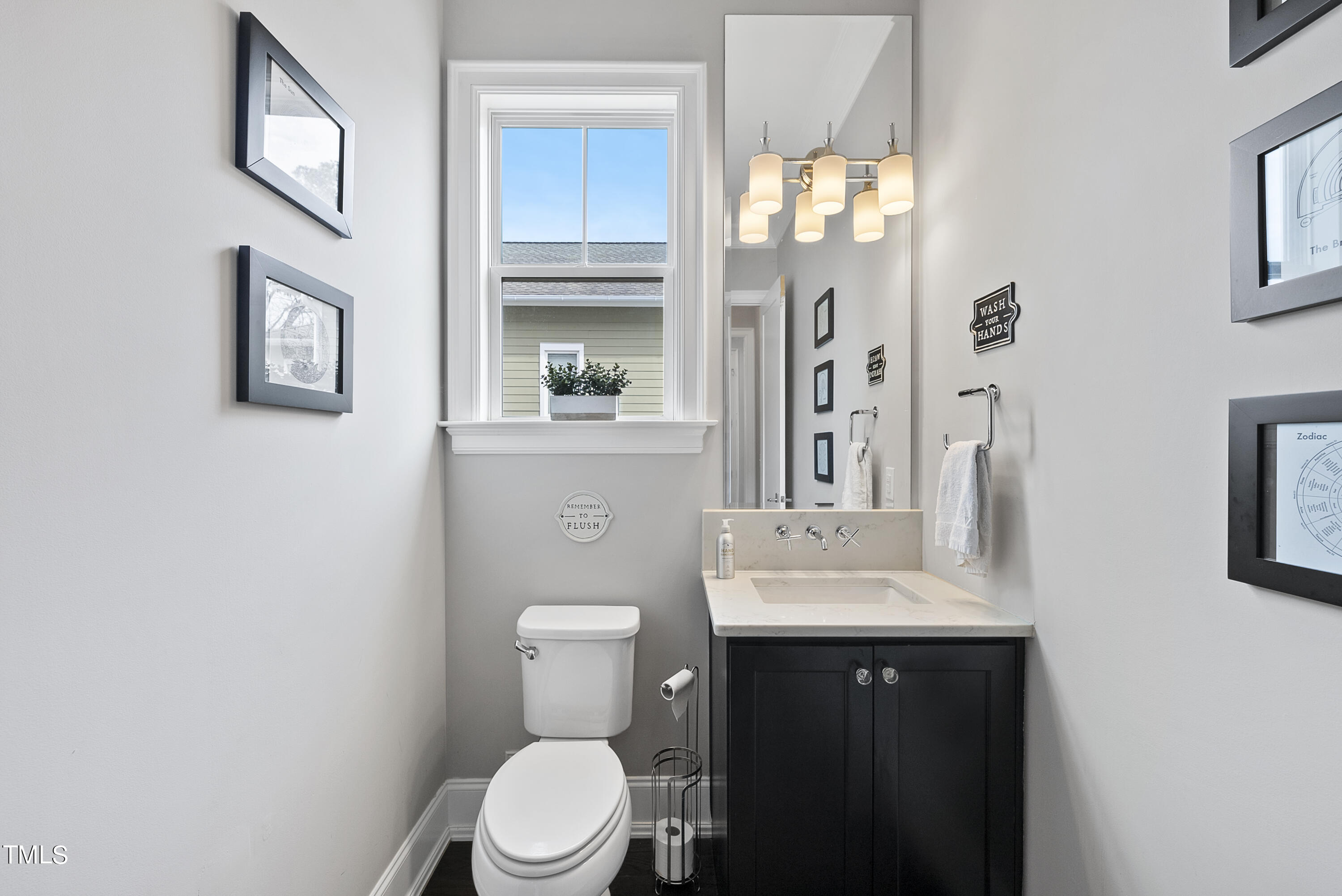 512 Mial Street Raleigh, NC 27608 - Photo 13 of 32 a bathroom with a toilet a sink and mirror