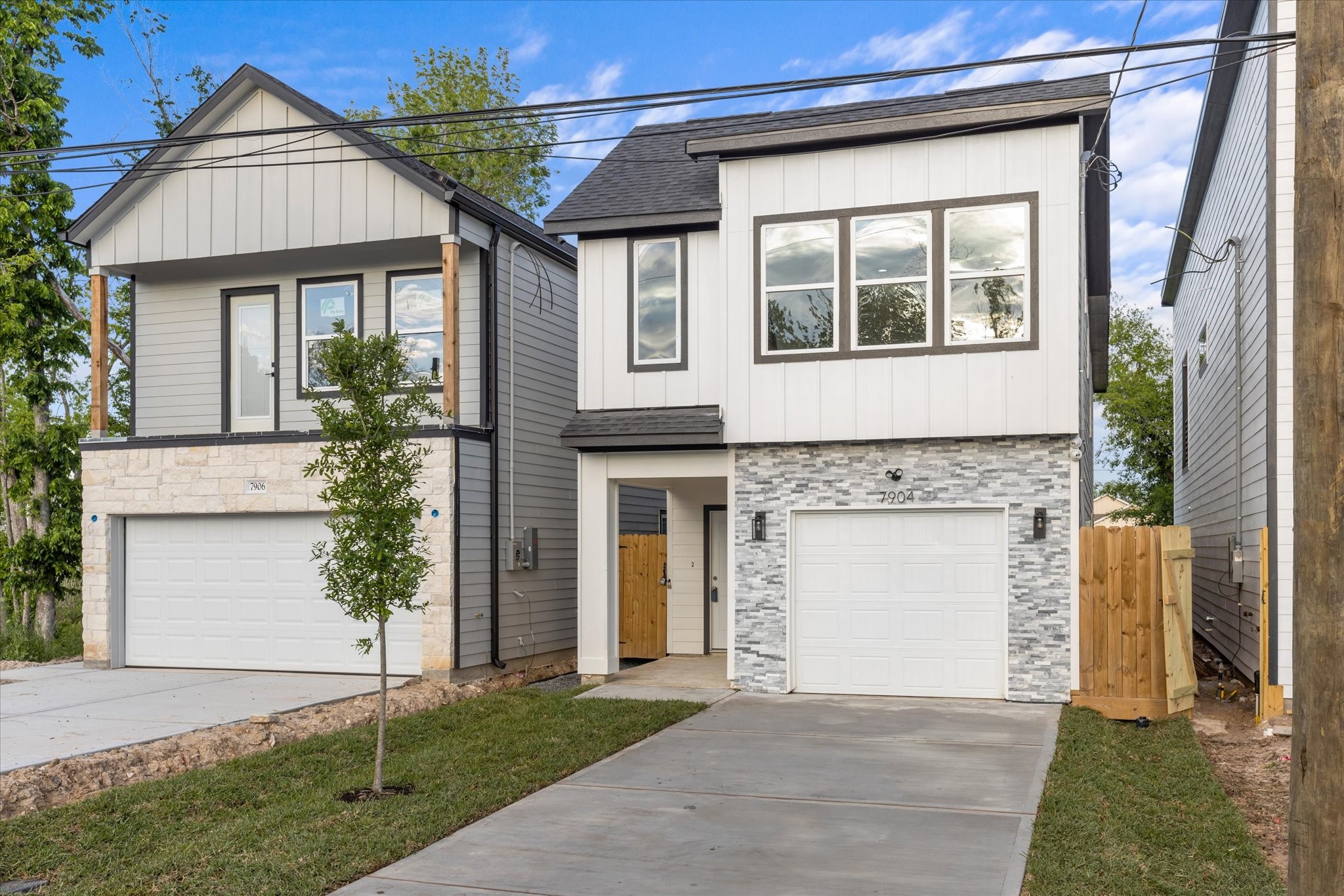 a front view of a house with a garden and yard