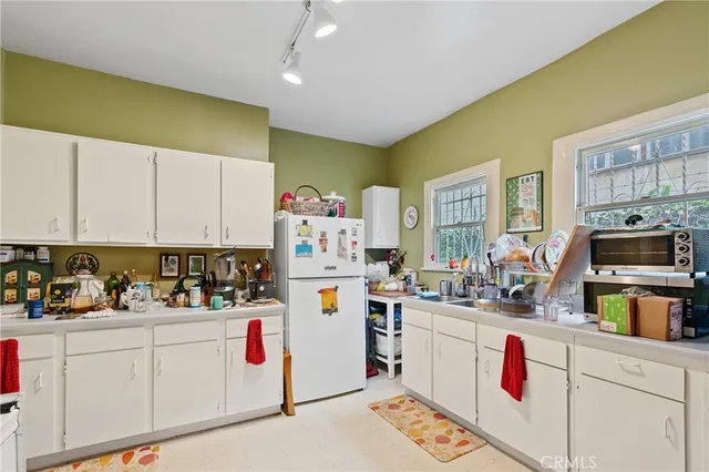 a living room with furniture a window and a flat screen tv