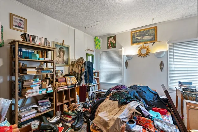 a room with white cabinets and wooden floor