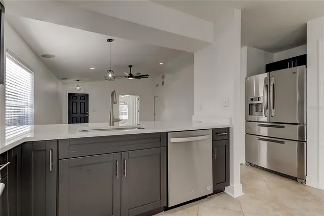 a view of kitchen with stainless steel appliances wooden floor
