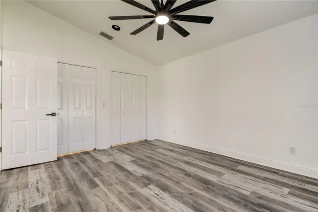 a bathroom with a granite countertop sink a toilet and a mirror