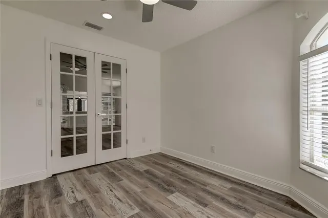 wooden floor in an empty room with a window