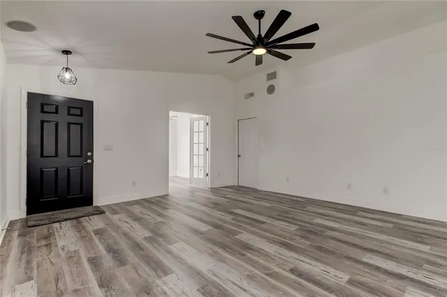 wooden floor in an empty room with a window