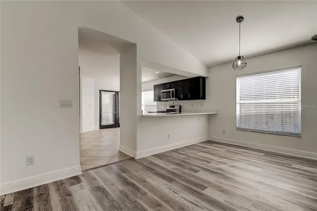 a kitchen with granite countertop a stove a sink and a microwave