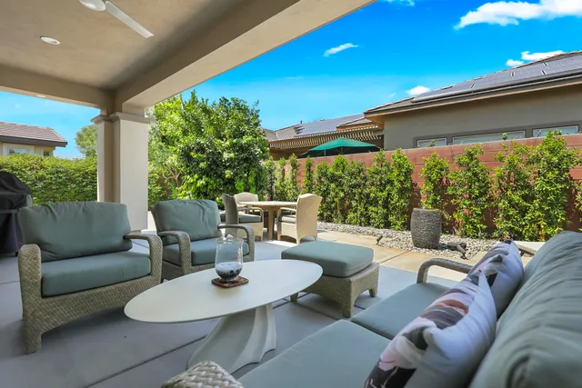 a view of a patio with table and chairs and potted plants