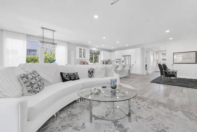 a living room with furniture and a dining table