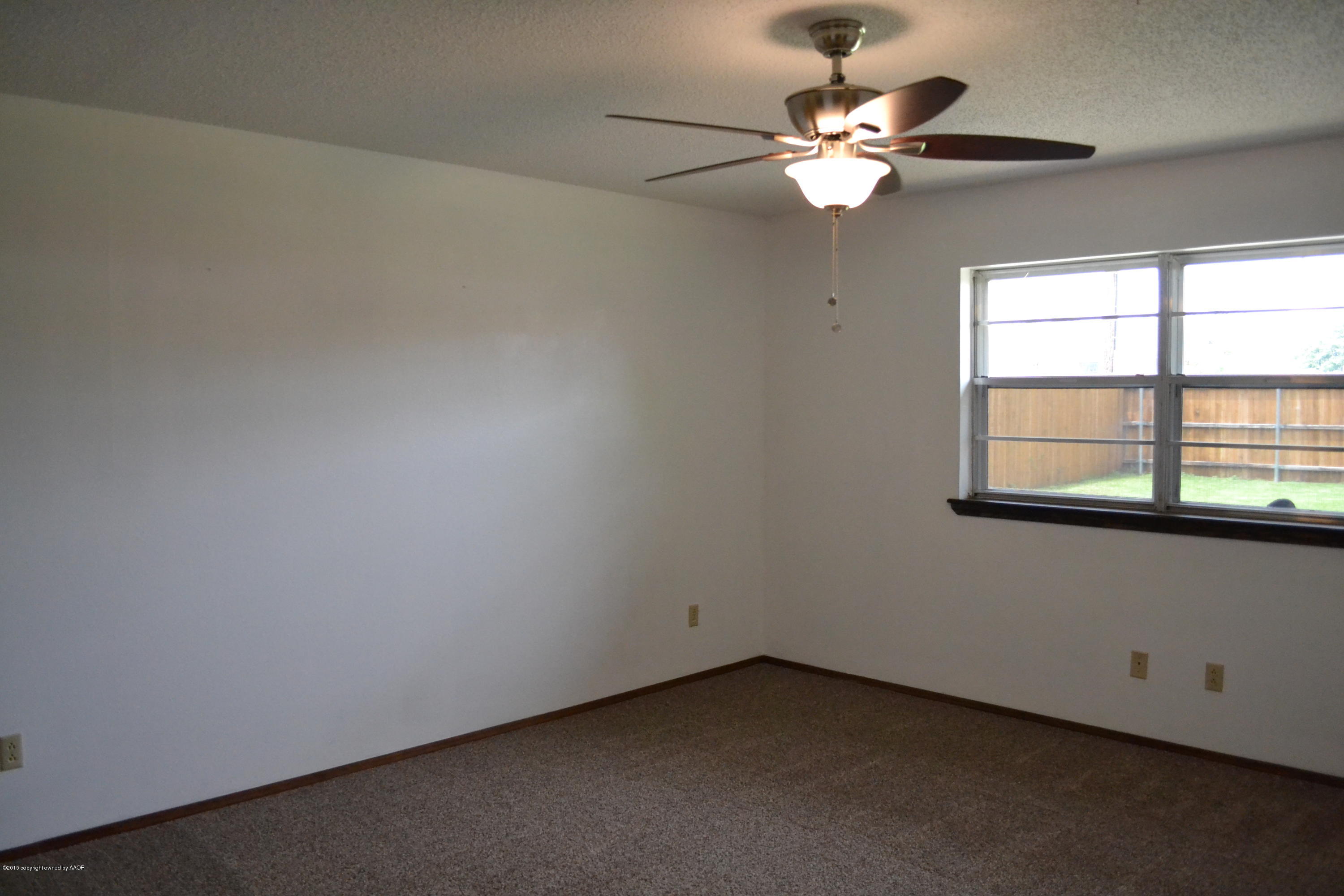 4910 South Georgia Street Amarillo, TX 79110 - Photo 36 of 70 an empty room with windows and fan