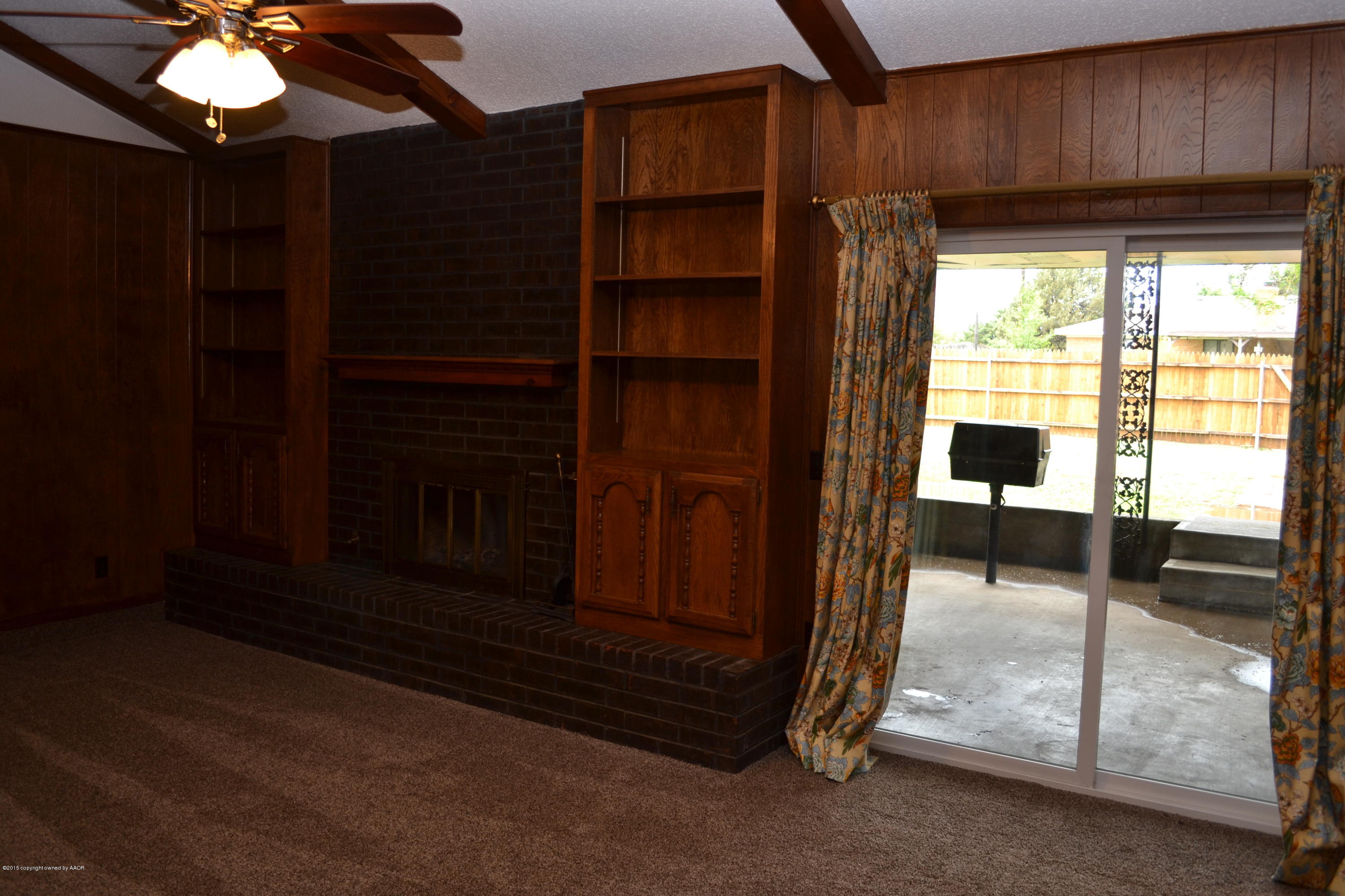 4910 South Georgia Street Amarillo, TX 79110 - Photo 8 of 70 a view of an empty room with a fireplace and a window