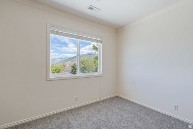 14883 Tooele Lane Draper, UT 84020 - Photo 31 of 49 White walls and gray carpeting, featuring a large window with mountain scenery and natural light