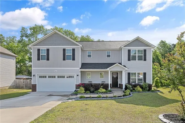 a front view of a house with a yard