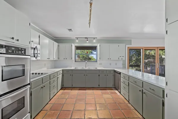 a large kitchen with a stove top oven