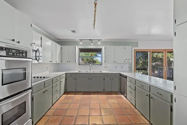 a large kitchen with a stove top oven