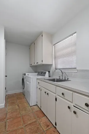 a kitchen with a sink and cabinets