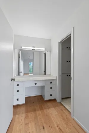 a bathroom with a sink vanity and mirror