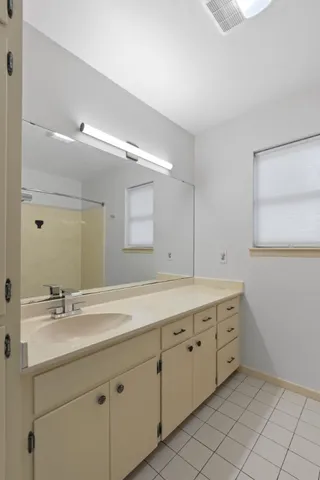 a bathroom with a sink vanity and mirror