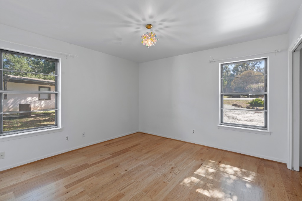 103 Comet Lakeway, TX 78734 - Photo 19 of 38 a view of an empty room with a window and wooden floor