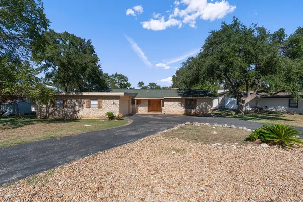 a front view of a house with a yard and a garage