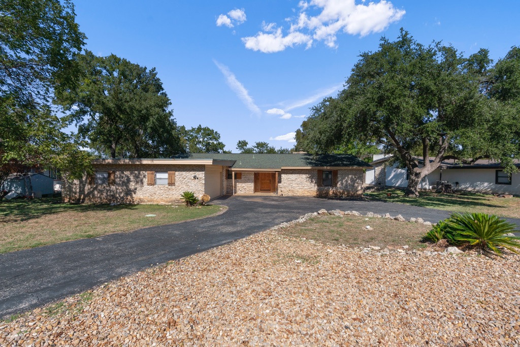 103 Comet Lakeway, TX 78734 - Photo 2 of 38 a front view of a house with a yard and a garage