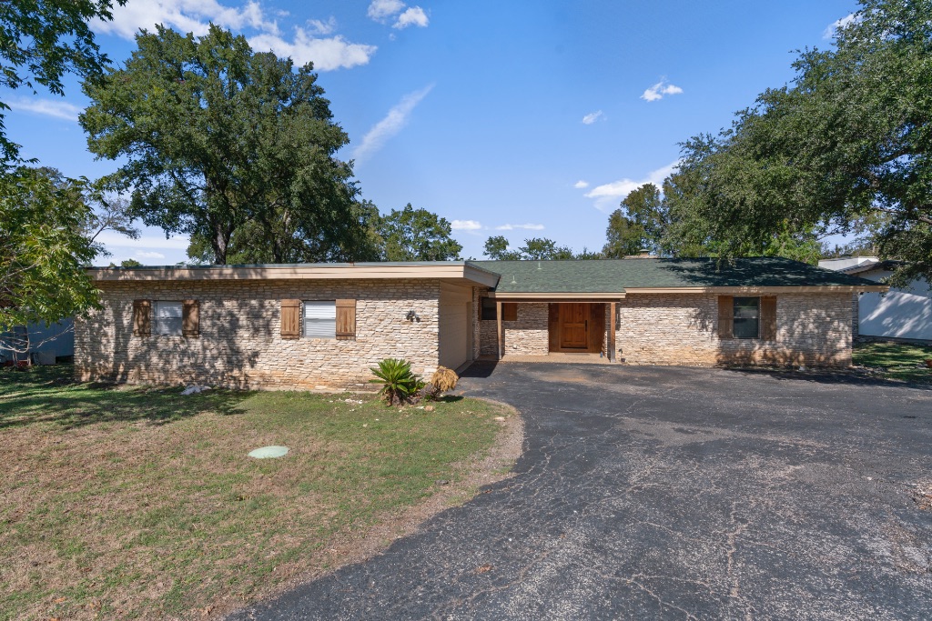 103 Comet Lakeway, TX 78734 - Photo 3 of 38 a view of a house with a yard and garage