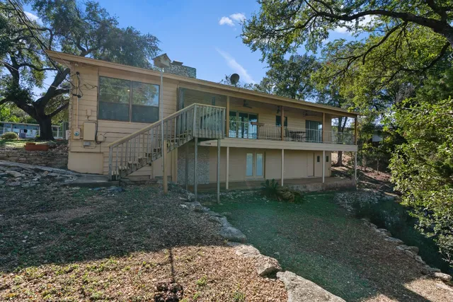 a view of a house with a yard and sitting area