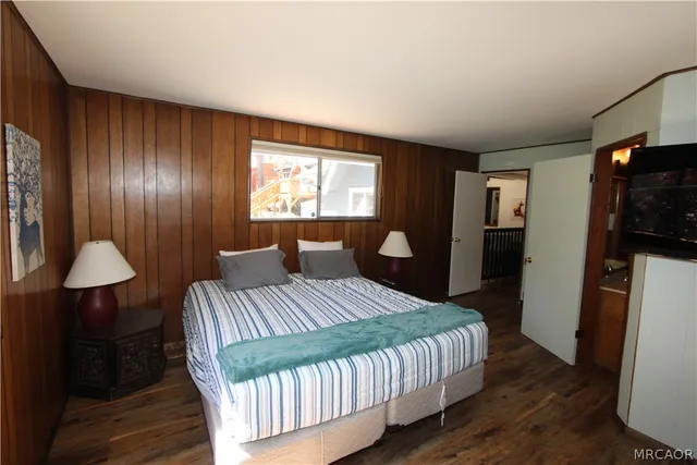 a bedroom with a bed and a dresser