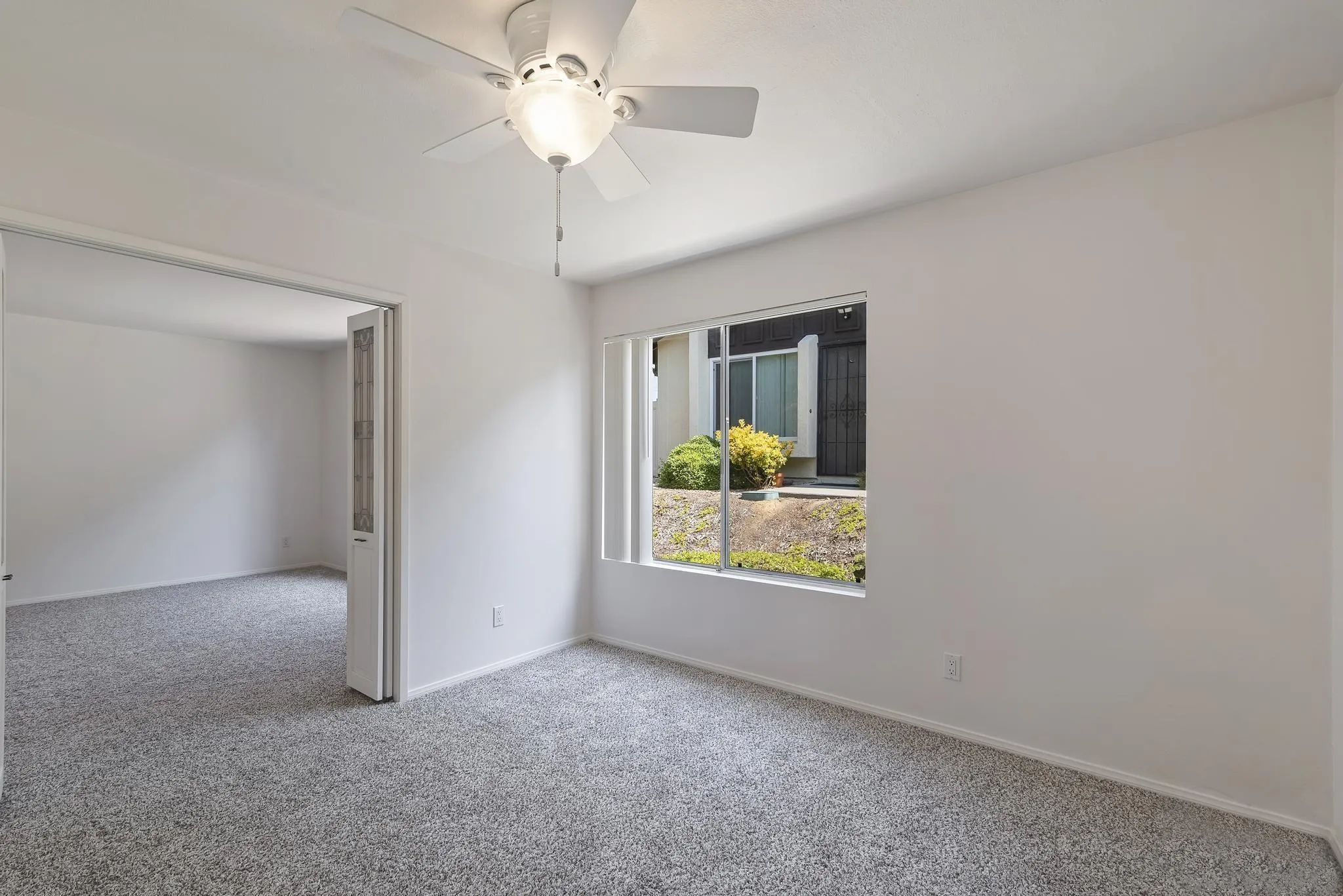 354 Abington Road Encinitas, CA 92024 - Photo 14 of 35 an empty room that has a window and a ceiling fan