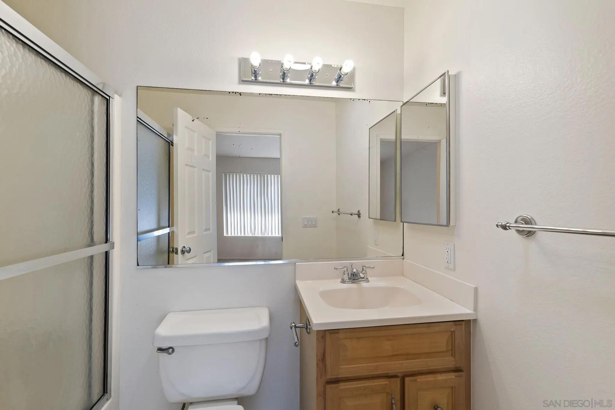 354 Abington Road Encinitas, CA 92024 - Photo 23 of 35 a bathroom with a sink a toilet and mirror