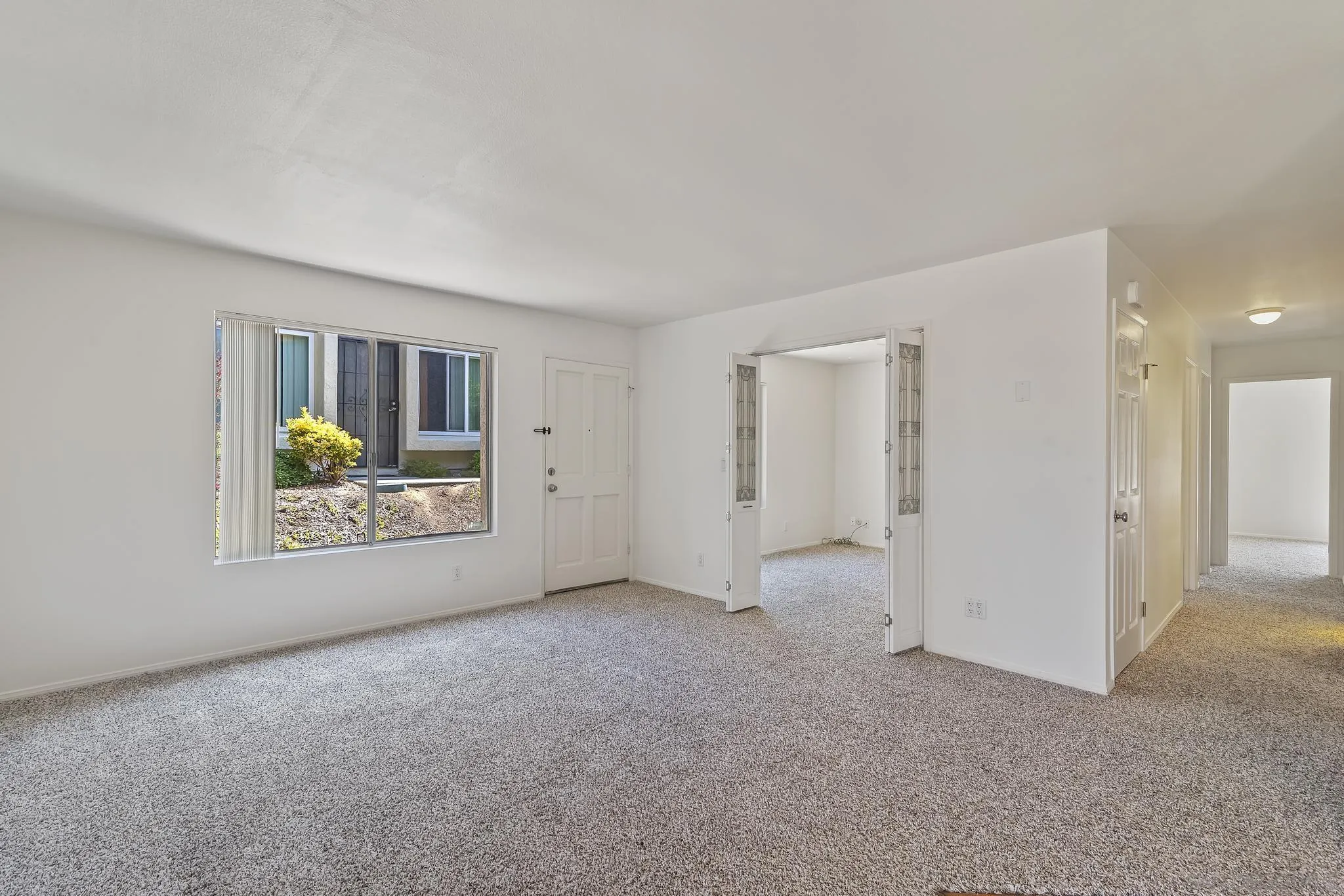354 Abington Road Encinitas, CA 92024 - Photo 5 of 35 a view of an empty room with a window and a kitchen