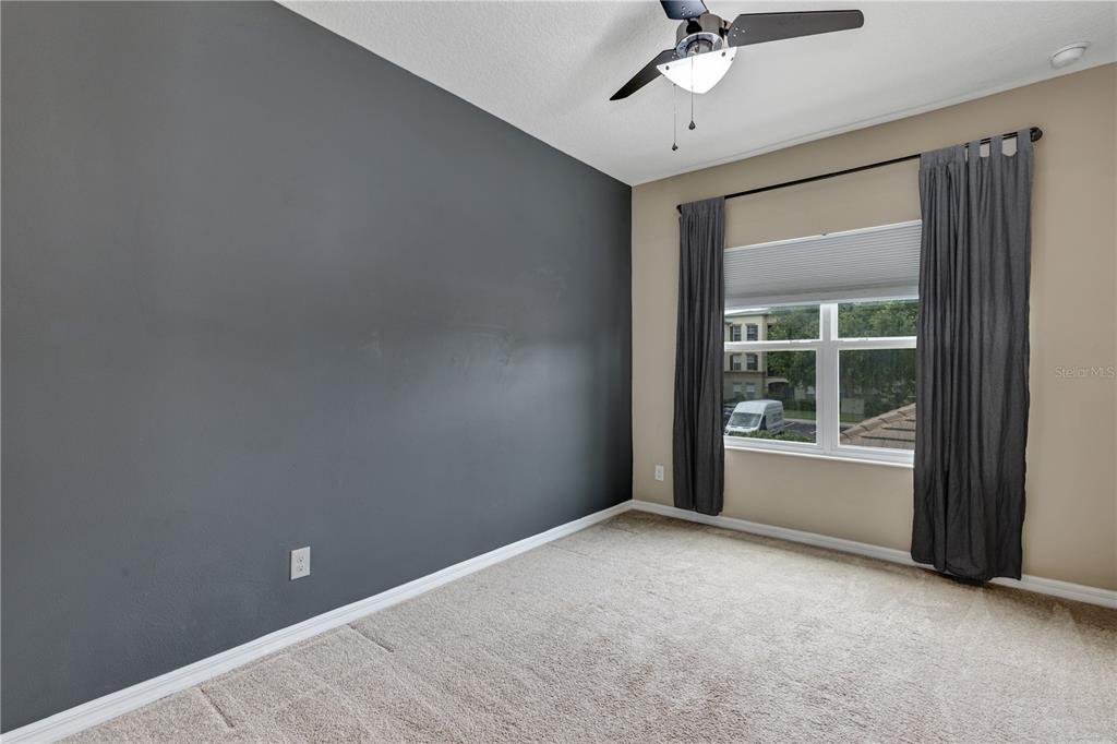 7644 Ripplepointe Way Windermere, FL 34786 - Photo 27 of 52 a view of a big room with windows and ceiling fan