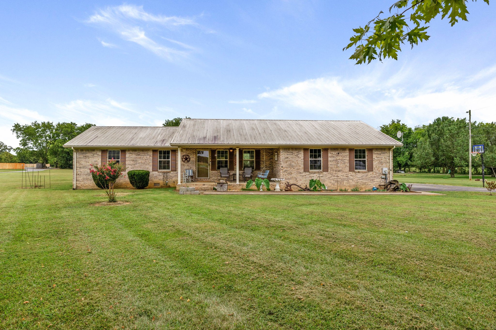 a front view of a house with a garden