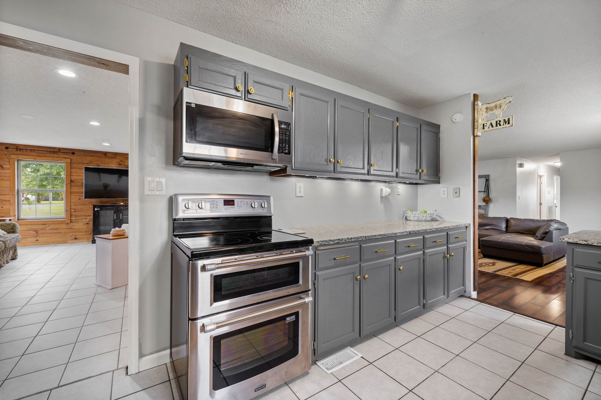 1146 Longview Road Unionville, TN 37180 - Photo 21 of 55 a kitchen with granite countertop a sink and stainless steel appliances