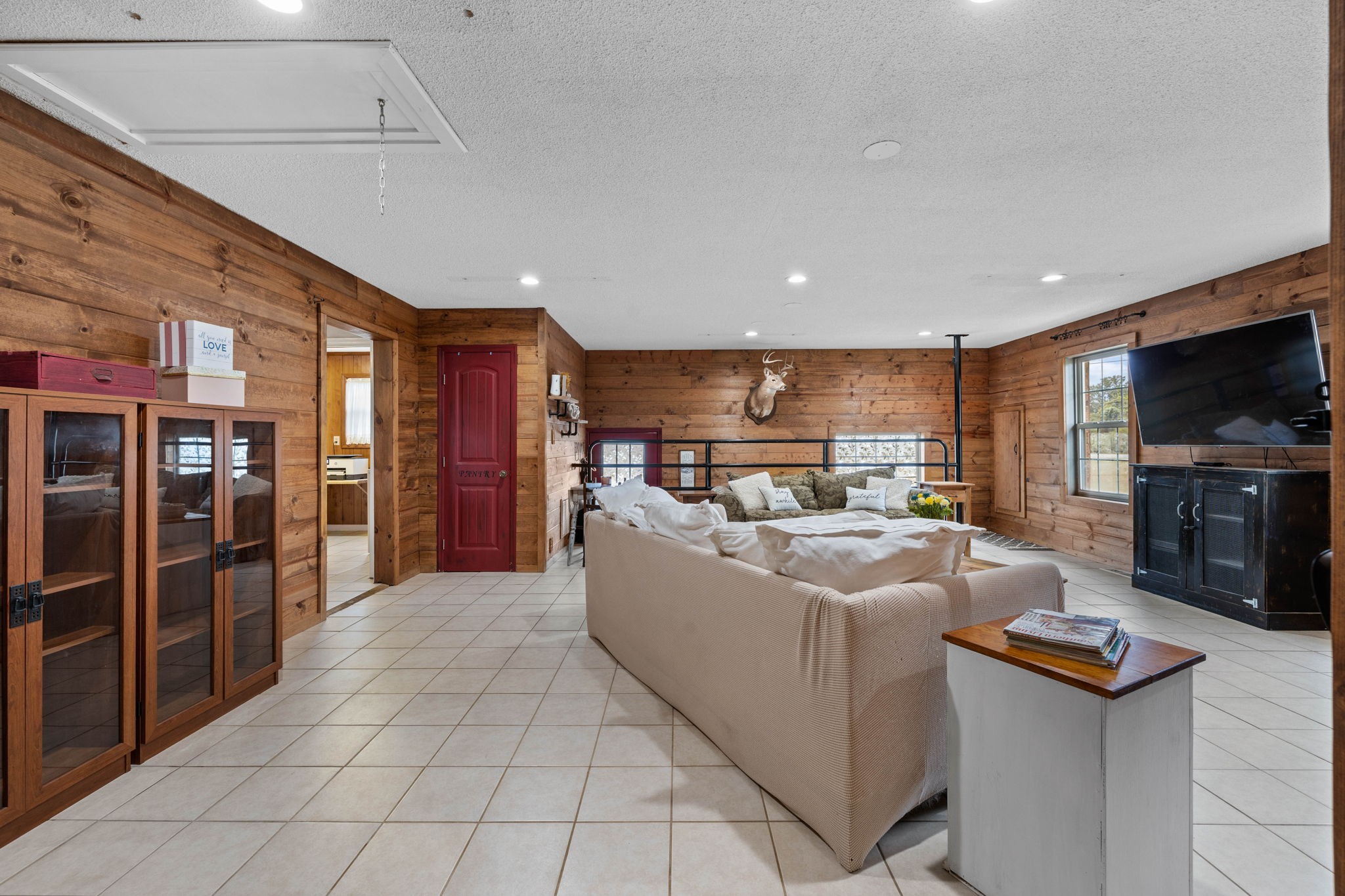 1146 Longview Road Unionville, TN 37180 - Photo 23 of 55 a living room with furniture a flat screen tv and kitchen view