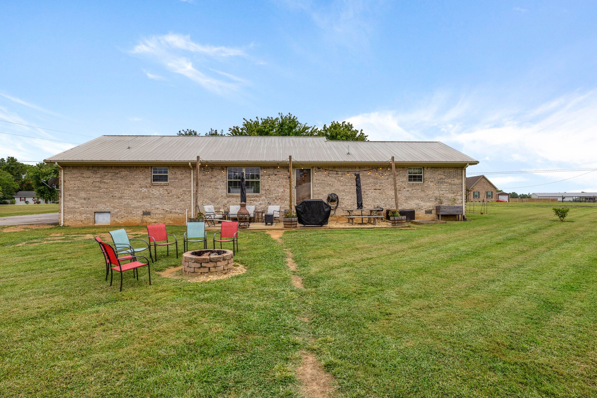1146 Longview Road Unionville, TN 37180 - Photo 37 of 55 a view of a house with a backyard and a patio