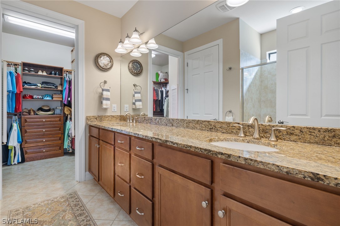 10845 Dennington Road Fort Myers, FL 33913 - Photo 12 of 46 a bathroom with a granite countertop sink and a large mirror