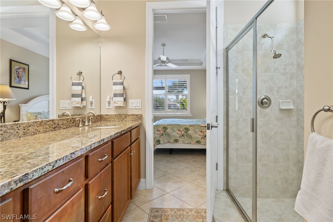 10845 Dennington Road Fort Myers, FL 33913 - Photo 13 of 46 a en suite bathroom with a granite countertop sink mirror and shower
