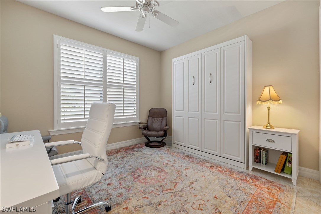 10845 Dennington Road Fort Myers, FL 33913 - Photo 14 of 46 a living room with furniture a fireplace and a flat screen tv