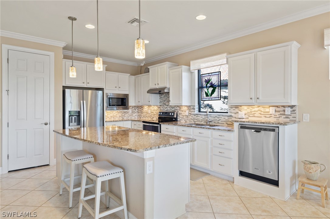 10845 Dennington Road Fort Myers, FL 33913 - Photo 2 of 46 a kitchen with stainless steel appliances granite countertop a sink and a refrigerator