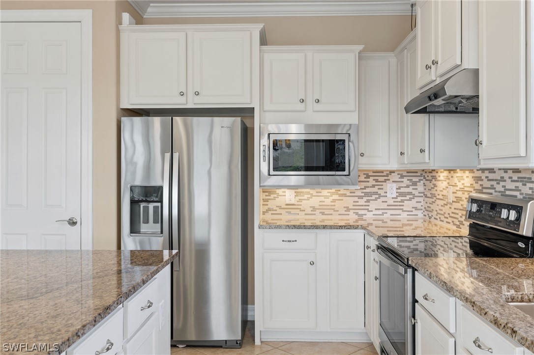 10845 Dennington Road Fort Myers, FL 33913 - Photo 23 of 46 a kitchen with granite countertop a refrigerator stove and sink