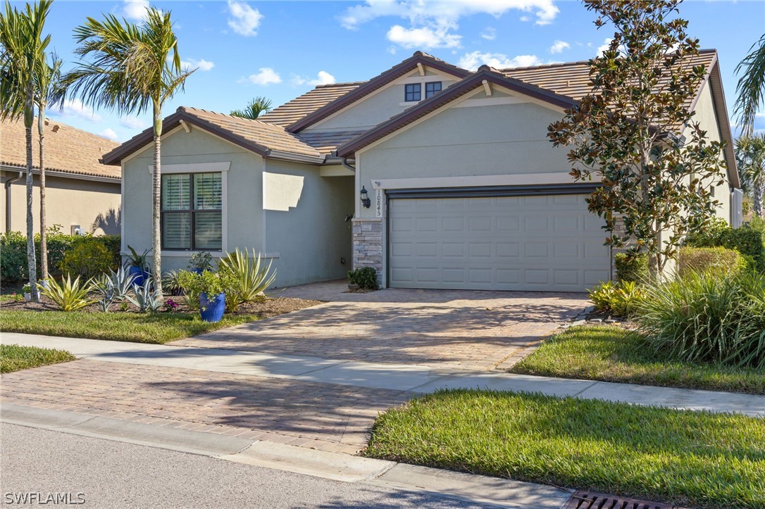 10845 Dennington Road Fort Myers, FL 33913 - Photo 26 of 46 a front view of a house with a garden and entryway