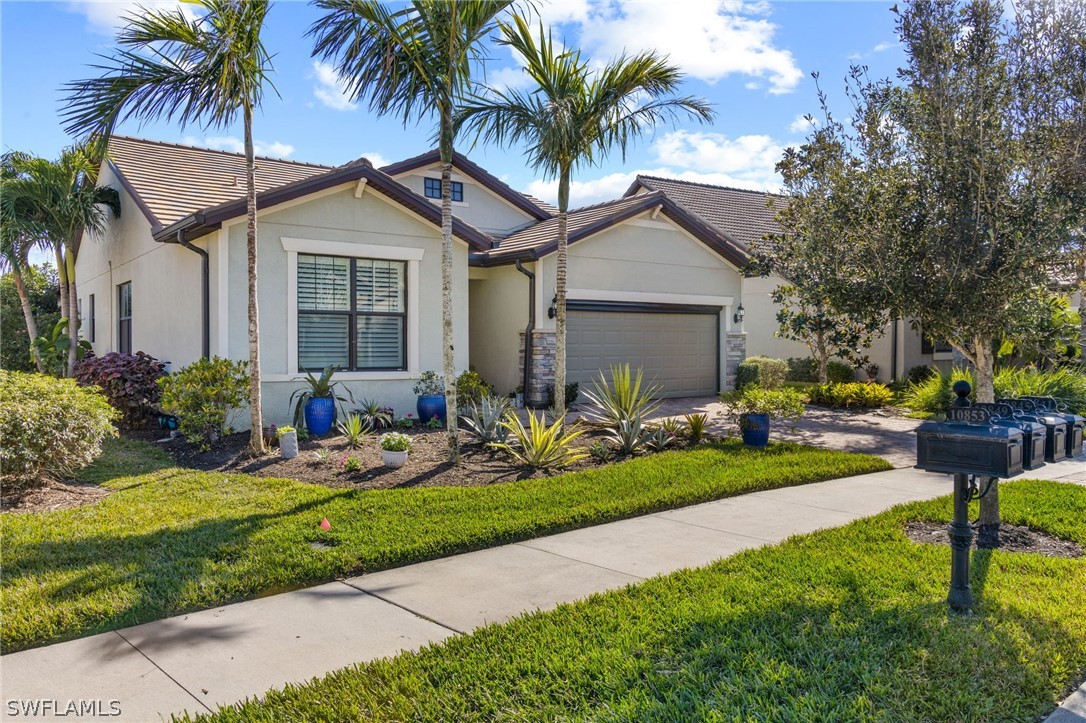 10845 Dennington Road Fort Myers, FL 33913 - Photo 27 of 46 a front view of house with yard and green space