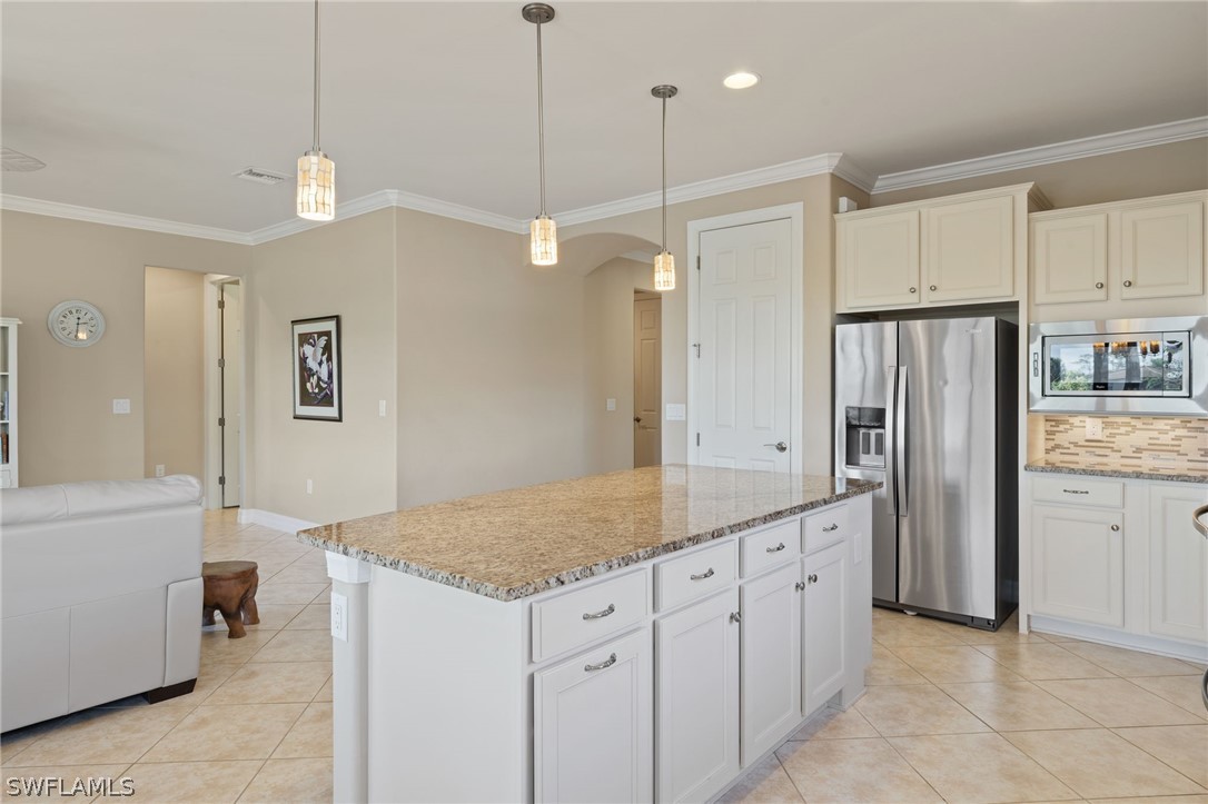 10845 Dennington Road Fort Myers, FL 33913 - Photo 5 of 46 a kitchen with stainless steel appliances granite countertop a refrigerator a sink and a stove